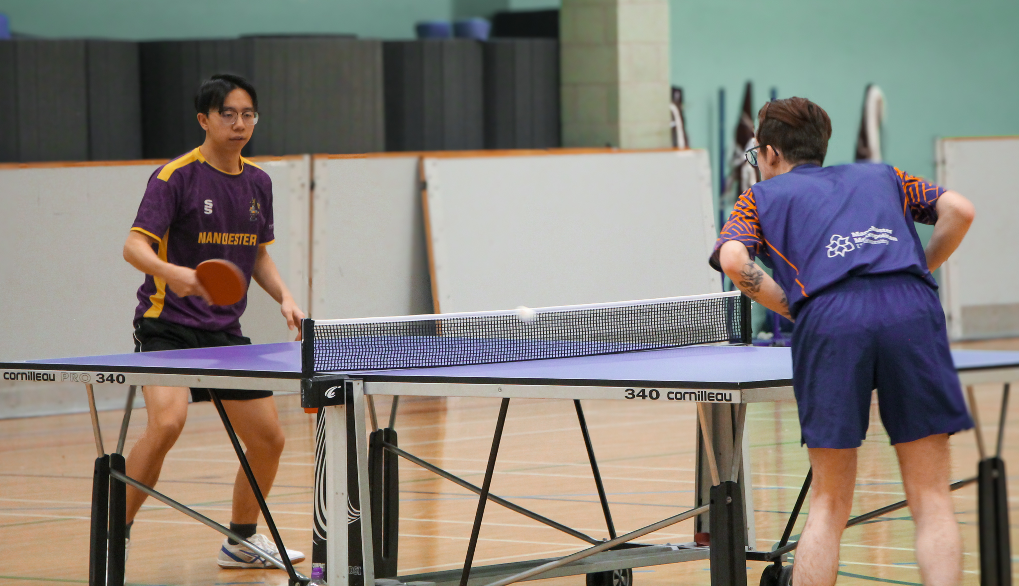 Manchester Met student playing table tennis against University of Manchester student