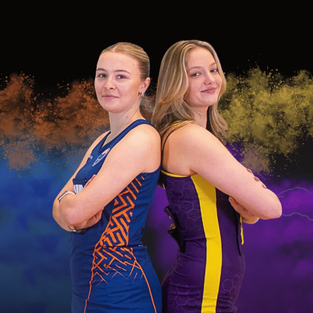 Two netball players posing back-to-back in playing kit.